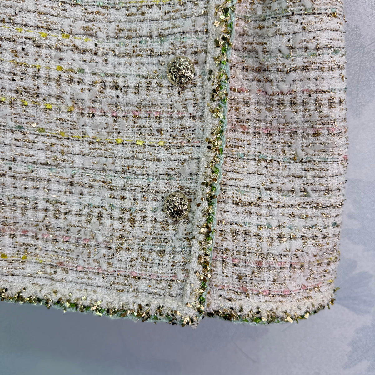 A light beige tweed blend short-sleeved jacket